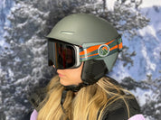 Woman wearing STAGE Custom Ski Goggles featuring Adaptive Sports Partners goggle strap on the STAGE Prop Black with Mirror Chrome Lens.